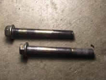 on top is one of the upper bolts and the bottom is the shorter lower bolt (you cant see the threads that it stripped out on it cause i cleaned it off)