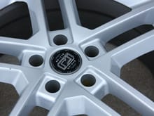 Here is a closeup of it.  I never noticed in person but I did only after taking this picture, you can actually see a slight paint drop from when they refinished the wheel and must have sprayed too much.  See below the lug bolt holes.  You won't notice that in real life, just pictures or now looking for it.