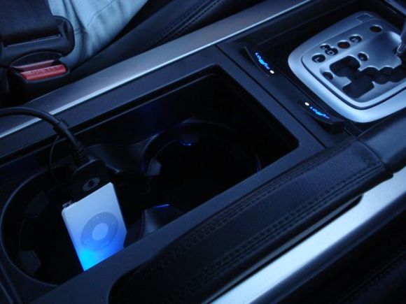 Center console with cup holder illumination. Seat heater switches glow blue and have white indicators.