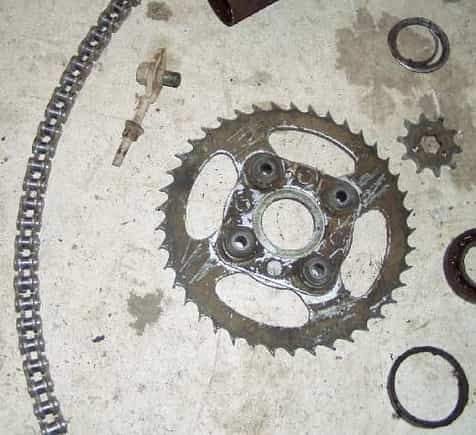 some of the parts off of the 185s.  on the left, the chain that will make a half circle, middle dead rear sporcket, bottom left axle bearing remains                                                    