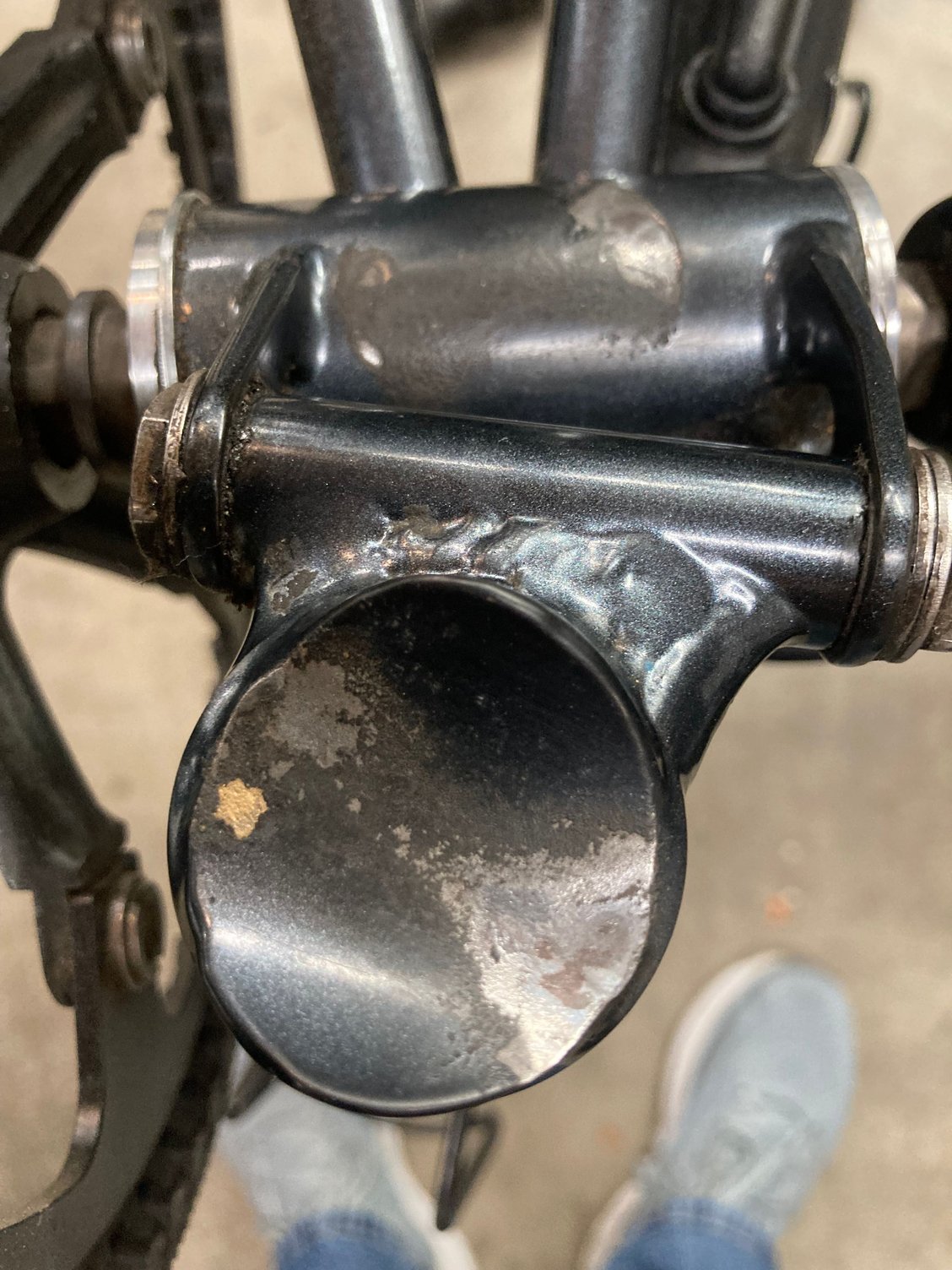 Bare metal exposed where seat post and bottom bracket make contact during riding. Anyone else experienced this. Do I have a henge problem.