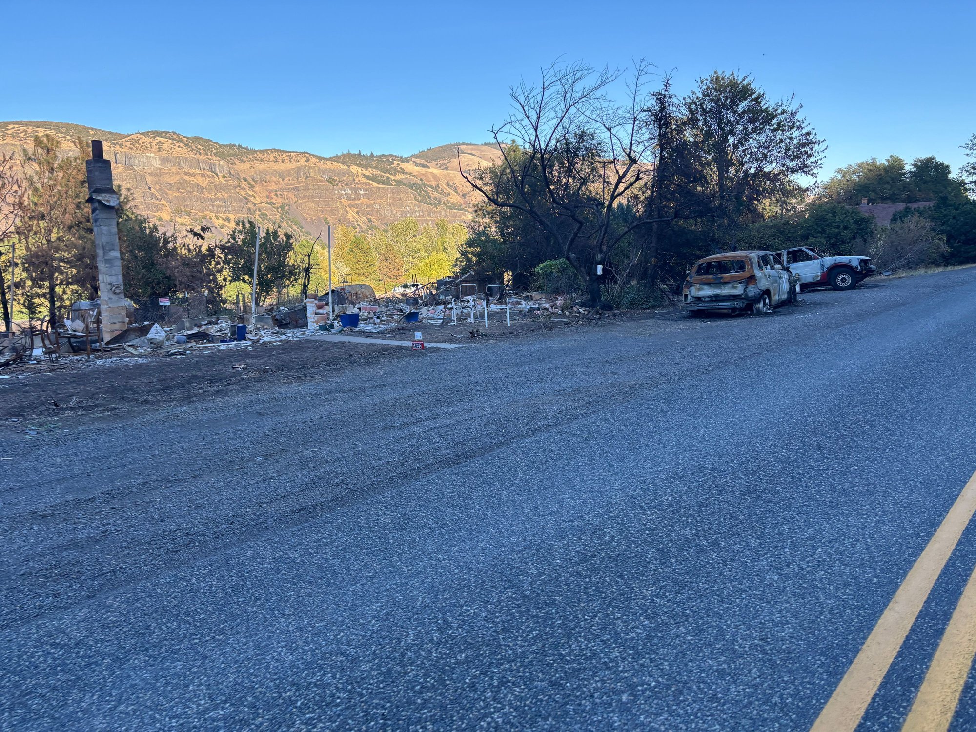 Rowena fire area. Burned to the foundation, next door, a home untouched by fire...