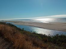 The mouth of Baduat'/Mad River in the foreground, sea lions on the edge. 