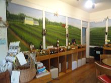 The room off to one side with artwork from the vineyard and ample supplies of wines.