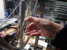 The fingers are used to check the tension.  My sense of touch is probably as good as the fancy meters so I use just my hands for this.