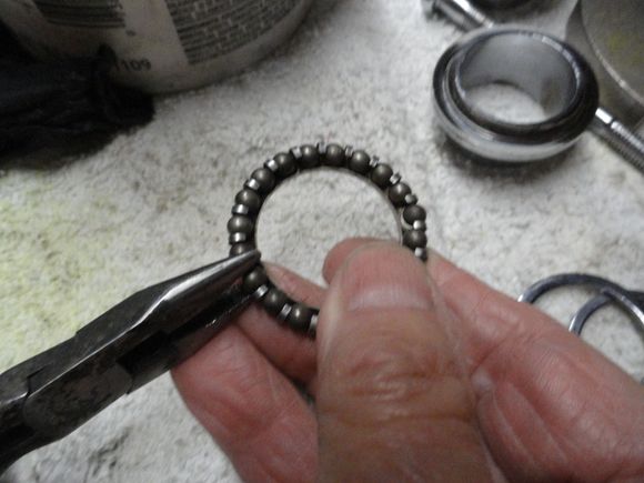 process of removing bearings from the cage