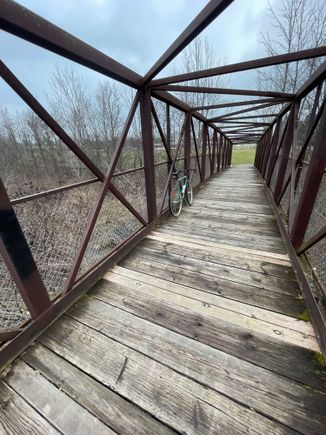 This little bridge joins a park to an elementary school. It’s pretty short, but the design and patina appeal to me.  And, it’s a SteamRoller a classic yet? I think Surly is ending production. Maybe a classic and not yet vintage…
Feel free to report me if I’m breaking the rules…😬