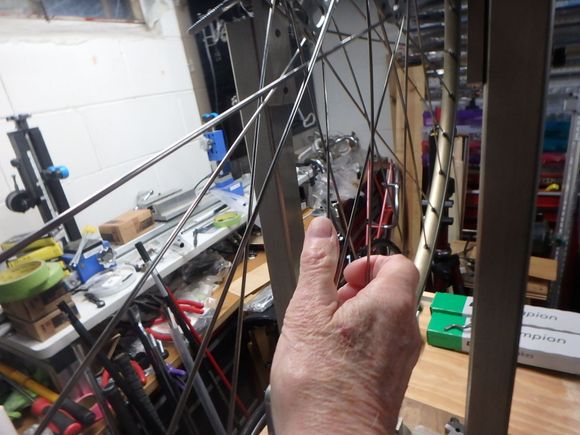 The onboard tension meter!   By compressing the pairs of spokes together,  they seat in and stretch a little bit.  The amounts that each one will stretch will make the wheel slightly out of true.
