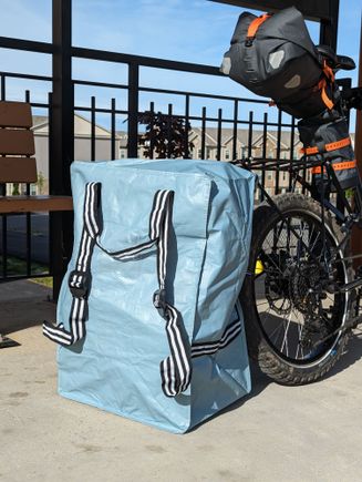 Really handy Ikea bag/backpack. Big enough to hold 2 x 17 liter panniers + 2 x 4.1 liter fork bags + ~10 liter drybag + misc