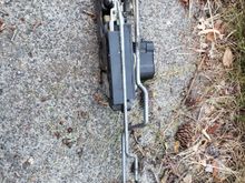 The old, and likely perfectly fine door lock mechanism. I took this picture so that I could remember how the linkages to the door handle and to the door lock attached.