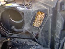needles packed in on the upstream side of the AC condenser by behind where the Blower Motor Control Module mounts