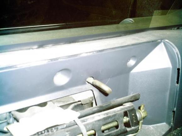 This is the hook that the hold-down grabs to hold tire in place. (plastic jack cover removed for clarity)