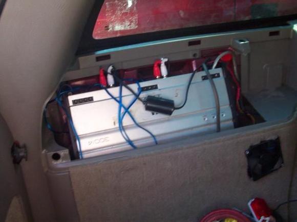 JL Audio 300/4 mounted in the Jack mount area w/ a PC fan wired in to keep it cool.