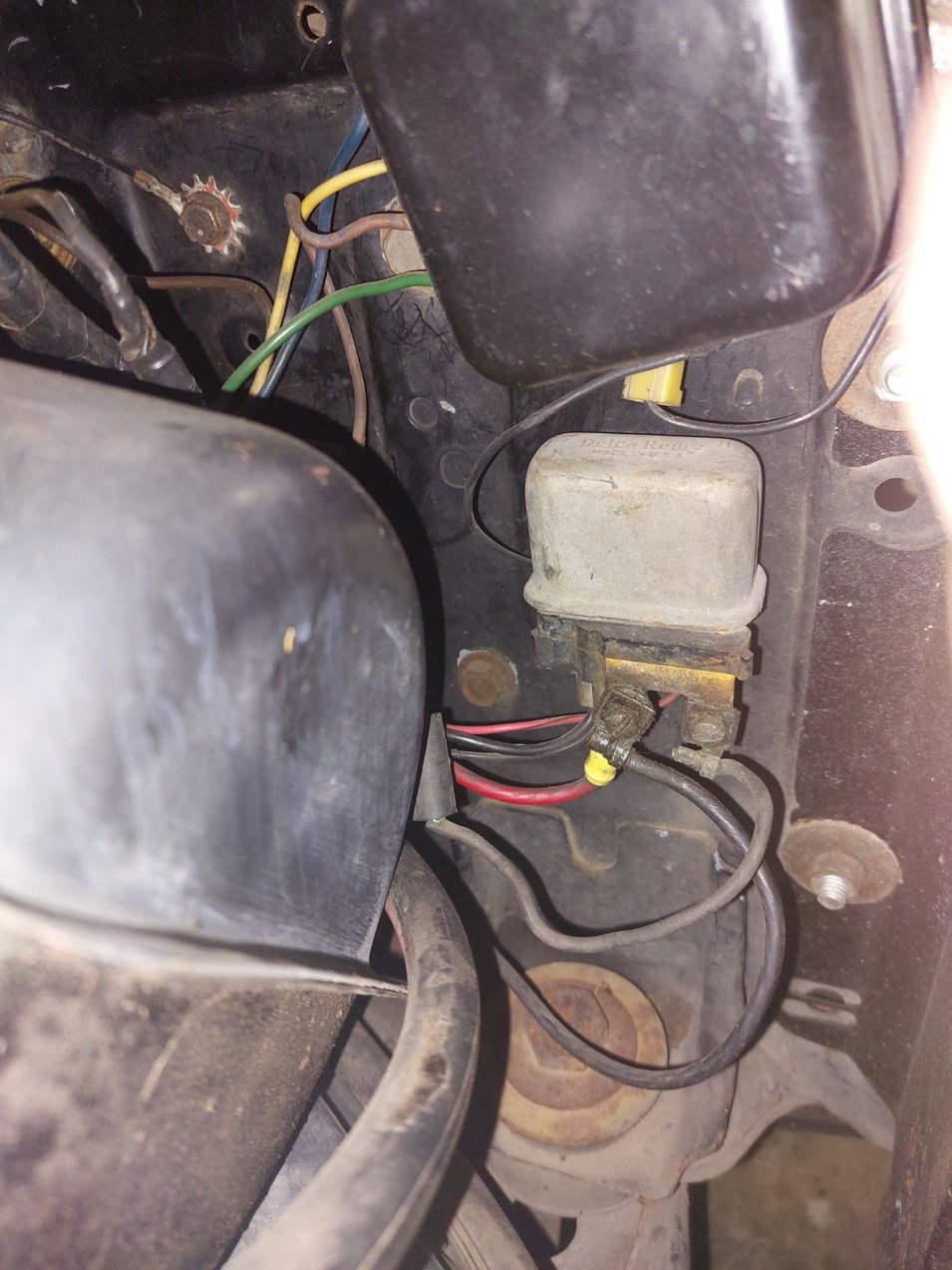 I have extra wiring as I added and AMP gauge in the circuit. The voltage regulator is above the horn relay and is used for the original 10DN alternator.