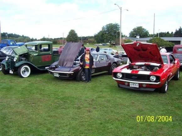 my wife with my camaro and corvette