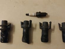 The melted spark plug boots, and one of the Autolite (shudder) spark plugs I removed.