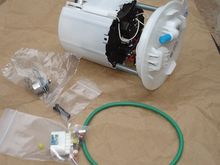 LS3 fuel pump module from a 5th gen Camaro.  The little silver cylinder is the 4th gen poppet valve.