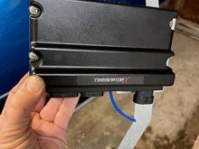 The bracket bolts to the fender and core support through rubber isolation mounts.  The ECU is mounted on rubber washers as well for additional vibration protection.