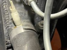 This pic shows the temp probe for the AutoCool fan controller is sandwiched between the radiator hose and the outlet port.