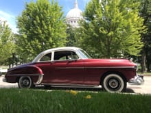 1950 76 dressed up like an 88.  Sitting in the Capital Square in Madison, WI.  Updates to this vehicle include 12v conversion, 6 cyl to 8 cyl (303 cid) conversion--including '54 324 heads and intake with a later Rochester 4v carb, all 88 brightwork, and currently receiving dual exhaust, front disc brakes, dual reservoir master cyl, rear shocks/air bags.  Still needs interior work, sound system, weather strip around doors and trunk.  I will drive this to Post Falls, ID this June for the NAOC meet