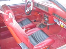 Interior of my 1978 Cutlass Calais.  The interior was originally red cloth but the previous owner re-upholstered the seats in red vinyl with black inserts.