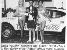 RON GAREY CHESROWN OLDS WINNER OF 68 SPRINGNATIONALS IN A 68 W-31.  FLANKED BY LINDA VAUGHN .