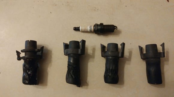The melted spark plug boots, and one of the Autolite (shudder) spark plugs I removed.