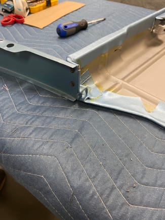 Metal filler panel screwed to armrest pad using original recoated screws 