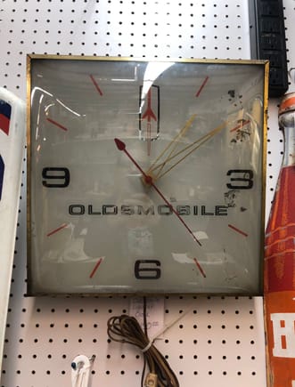 My question: ballpark figure on what it’s worth? How can I tell if it’s a reproduction or one of the real deal clocks that hung in showrooms?  It has a very old electric cord? It’s advertised as working, but I didn’t want to bother pulling it off the shelf and risk breaking it until I had some idea of what it’s worth. 
Thanks. 