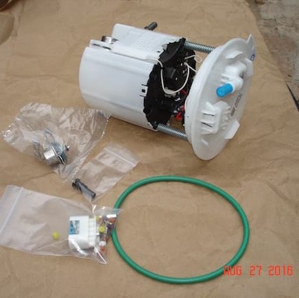 LS3 fuel pump module from a 5th gen Camaro.  The little silver cylinder is the 4th gen poppet valve.