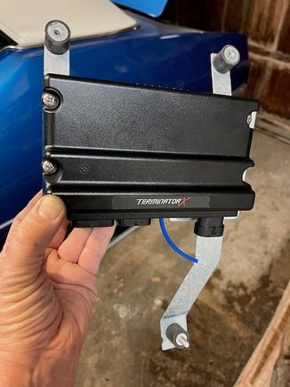 The bracket bolts to the fender and core support through rubber isolation mounts.  The ECU is mounted on rubber washers as well for additional vibration protection.