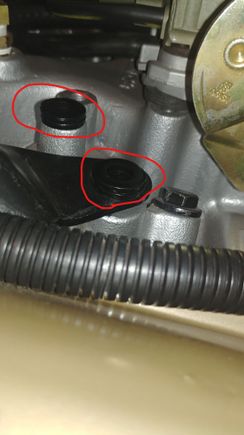 Get four thick washers and place over these two holes. This spaces the bell crank roller up on the cam for proper operation to get full throttle travel.