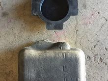 The 2.5” grommet (top) and square rubber piece that hides the grommet.