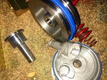 New HD Shift Technoiges front servo + HD piston vs the stock chewed up. Shifts' servo upgrade it literally about 5x as thick as the OE and the piston is much more HD as well.