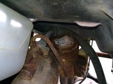 The adjustment parts are below the coolant overflow.