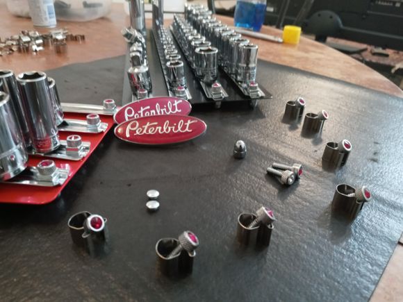 These socket trays i bought at Harbor Freight.
They have a carry handle but the sockets
Slide off the end of the socket rail.
when i picked it up.
So i drilled the rivets out.  And made stoppers
From 2 square nuts, acorn nuts, and really cool
Dashboard screws from my pete. 
So now i can pick it up and not worry,
The acorn nuts wont scratch either. 