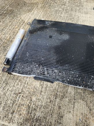 Condensor/trans cooler/dryer. You cant really see how bad this is, but its folded over almost 2" at that bottom portion