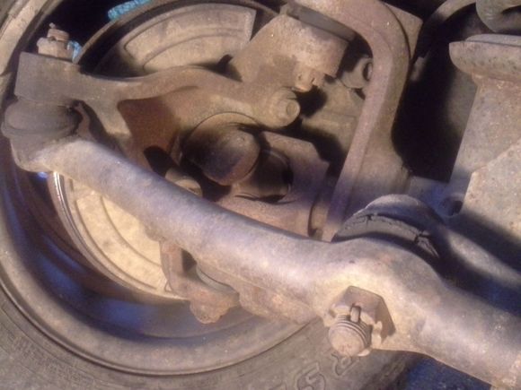 That ball joint's boot is open, has slits from dryrot, theres no grease in it. So is the other bushing to the right on the bar going to ball joint, so is that one up top on the part that 90's to the left. All dryrotted under the front and wheels wobble left to right, and that bar can be twisted by hand a 1/4 turn with ease. Is that normal? Also that ujoint slightly clinks back and forth a bit.