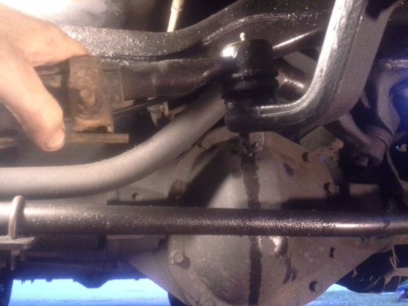 That fluid leaking there is pwr steering fluid(another problem needing fixed,just a hose but it leaks all over everything down there!) That's the bar I can twist about a 1/4 turn effortlessly. To the left it goes into the pass lower ball joint that's all dry rotted and that wheel wobbles at the 3oclock, 9oclock position. The right wheel doesnt do much better. This is with full lock to left.