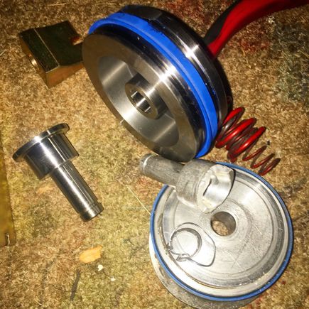 New HD Shift Technoiges front servo + HD piston vs the stock chewed up. Shifts' servo upgrade it literally about 5x as thick as the OE and the piston is much more HD as well.