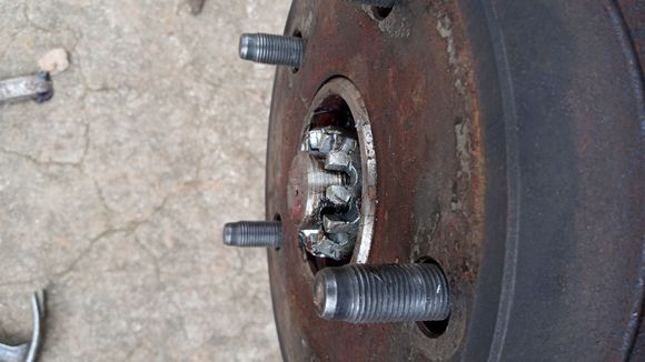 Axle nut threads wore smooth on both sides of both new axle and hubs , nut cutting into axle spindle 