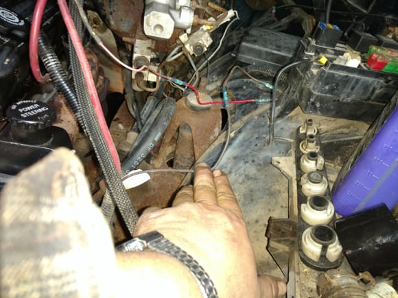 I believe this wire connects to the solenoid. I can'remember what the small red wire feeds. Both were rubbed through and had to be spliced.