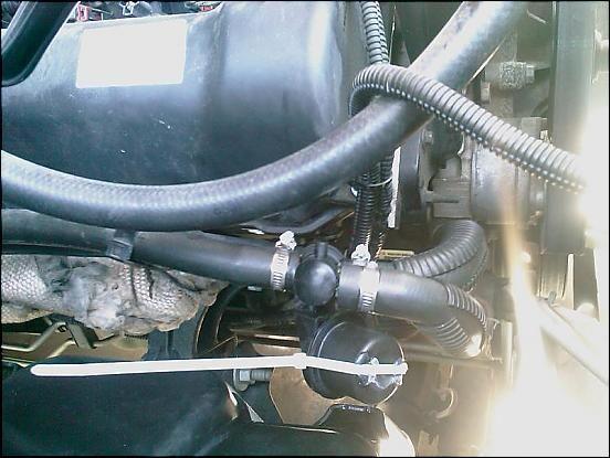 Here it is installed, with the tie wrap in place.  I do cut the tie wrap sometime in the fall, as it starts getting cooler.  One thing you'll notice with this mod, vent air is noticeably cooler also.