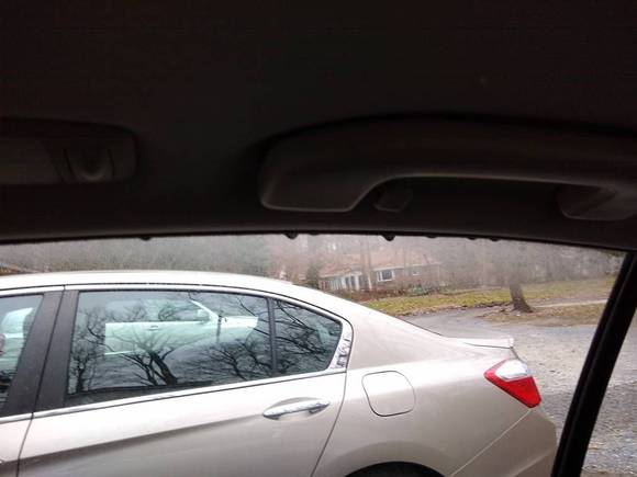 Water droplets hanging from back window. Inside looking out. Front window same. It was not raining when I took this.