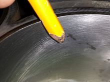 The pencil is for size reference and my concern is the dark "speck" directly to the right of it.