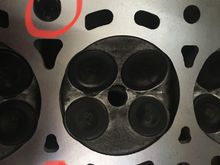 It looks like the oil flows around the bolt hole since it’s bigger than the one pictured on the bottom.