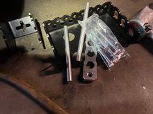 I know the two rods attach to the silver flat piece to hold battery down 