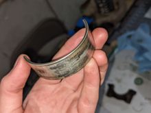 The worst of my main bearings. My con rod bearings don't look great either. None of them look particularly good, but I can't decide if they're fully spun or dangerously close to doing so.