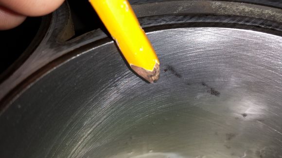 The pencil is for size reference and my concern is the dark "speck" directly to the right of it.