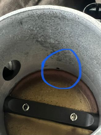 There is a small hose that connects to that pin hole. 